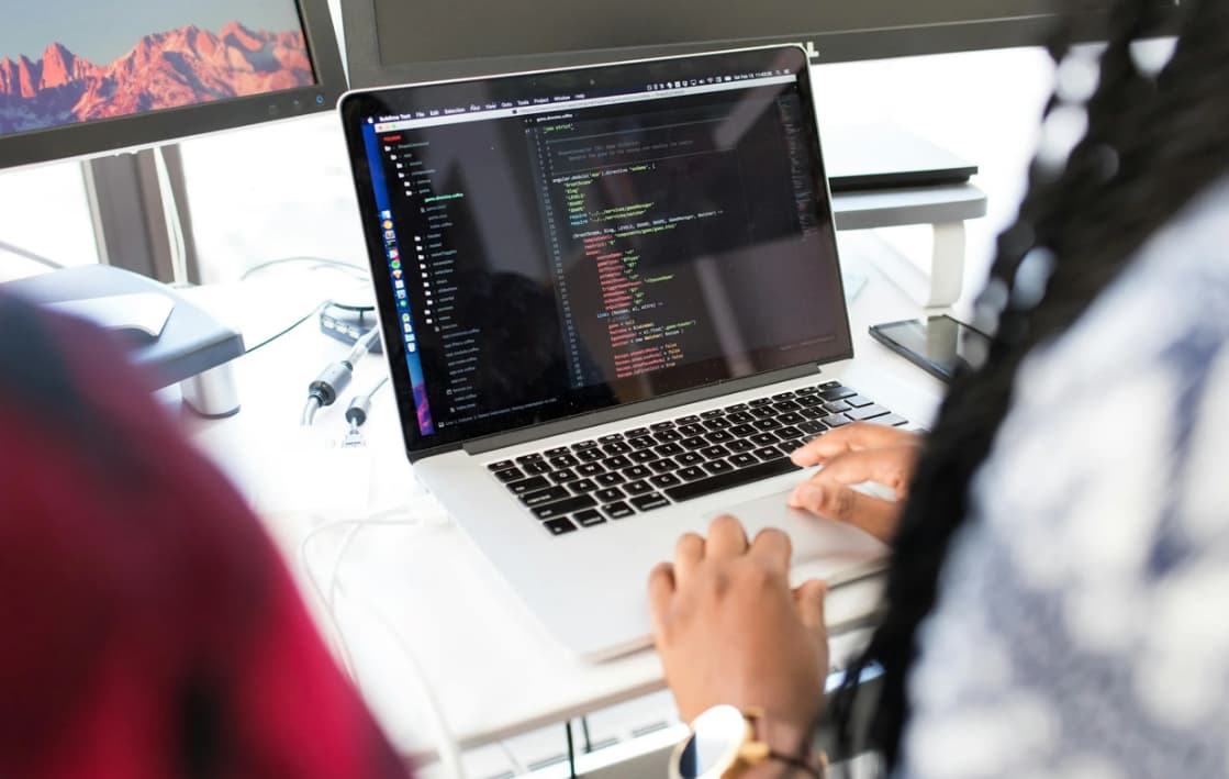 Person coding on a laptop